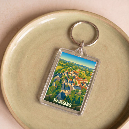 Porte-clés souvenir de la ville de Farges avec une illustration stylisée d'un paysage de village.