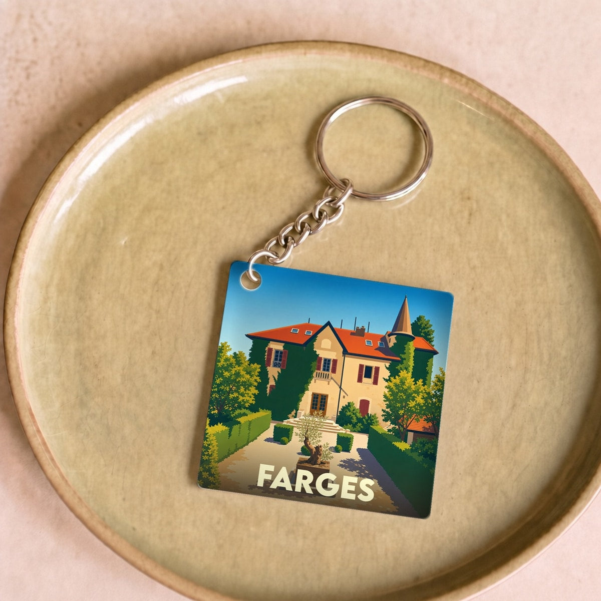 Porte-clés souvenir de la ville de Farges avec une illustration stylisée.