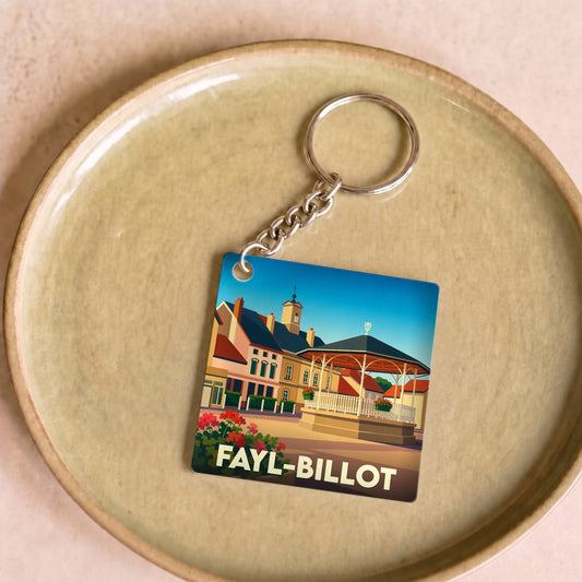 Porte-clés souvenir de la ville de Fayl-Billot avec une illustration stylisée d'un kiosque et d'un clocher.