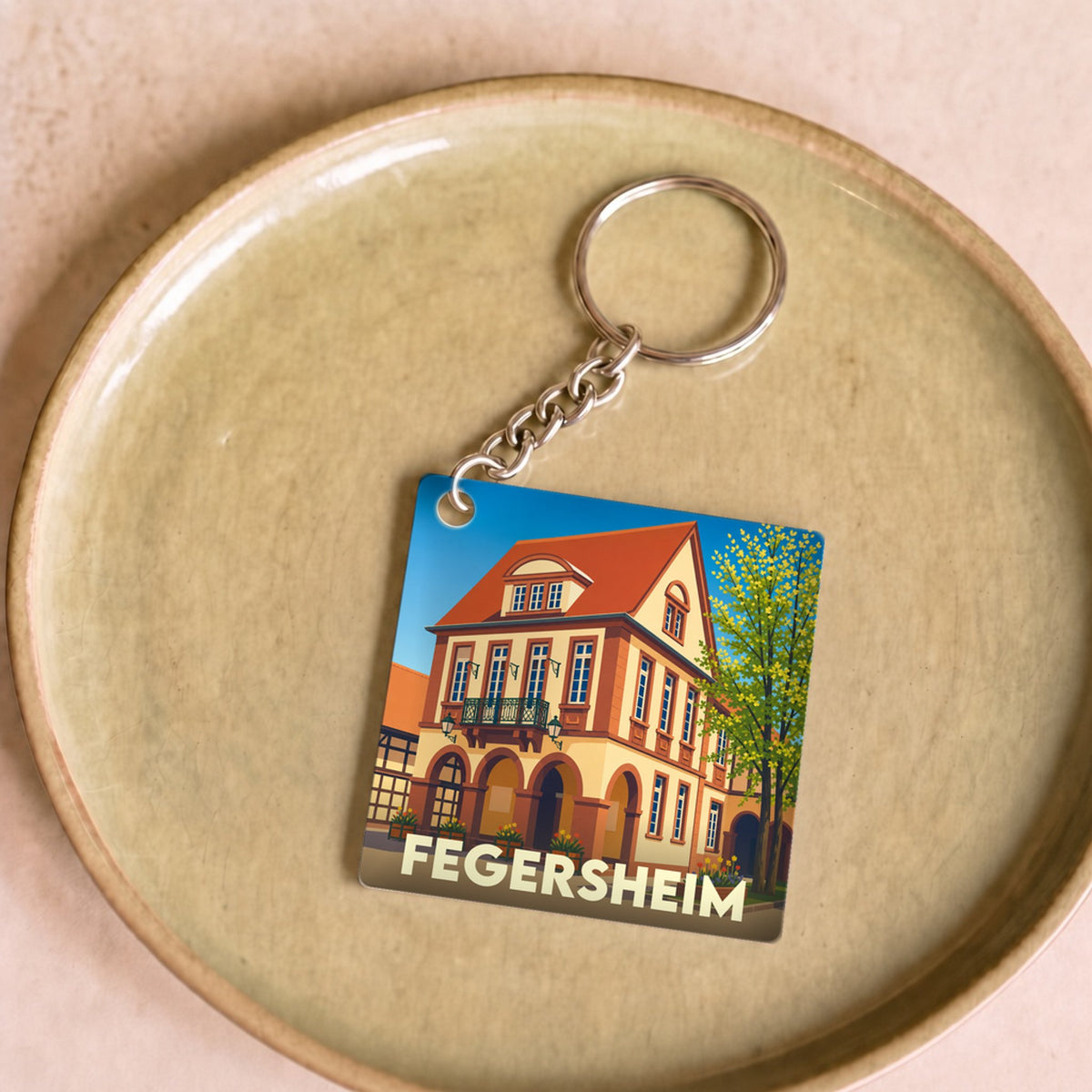Porte-clés souvenir de la ville de Fegersheim avec une illustration stylisée.