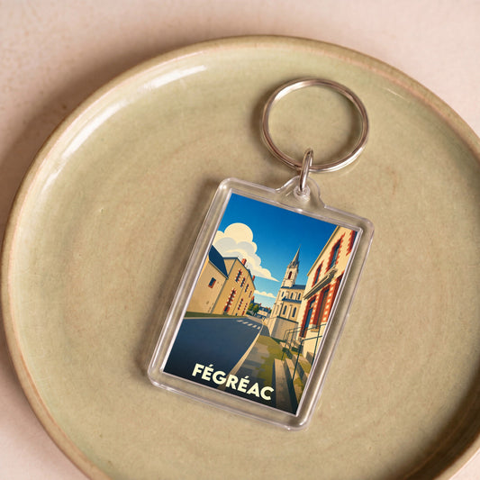 Porte-clés souvenir de la ville de Fégréac avec une illustration stylisée.
