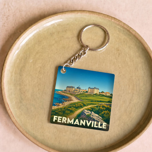 Porte-clés souvenir de la ville de Fermanville avec une illustration stylisée du littoral et du patrimoine local.
