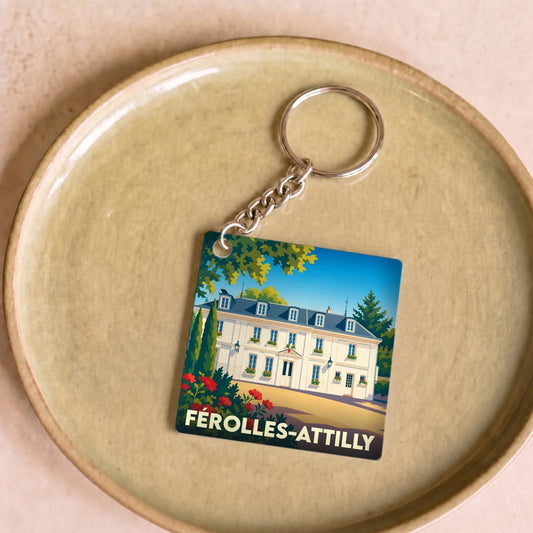Porte-clés souvenir de la ville de Férolles-Attilly avec une illustration stylisée.