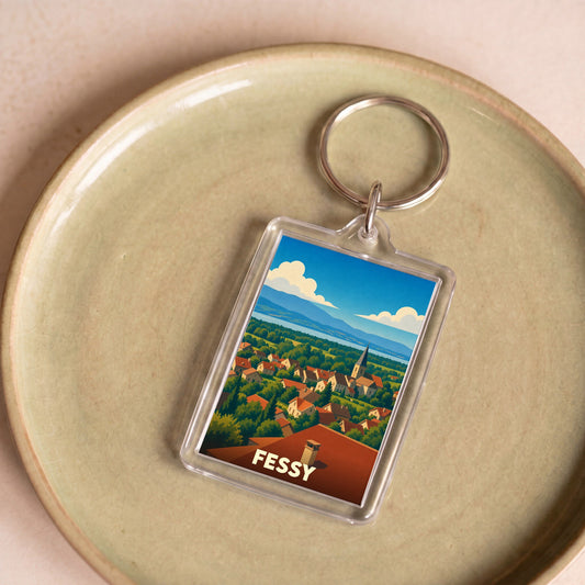 Porte-clés souvenir de la ville de Fessy avec une illustration stylisée de son paysage.