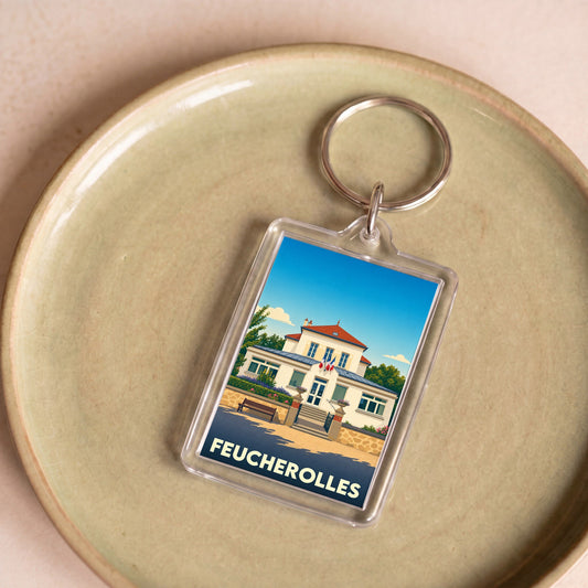 Porte-clés souvenir de la ville de Feucherolles avec une illustration stylisée de sa mairie.