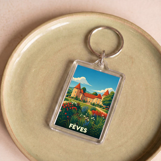 Porte-clés souvenir de la ville de Fèves avec une illustration stylisée d'un château et de jardins fleuris.