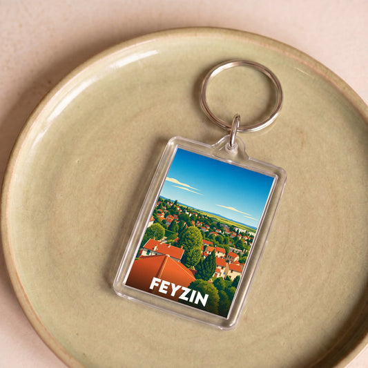 Porte-clés souvenir de la ville de Feyzin avec une illustration stylisée.
