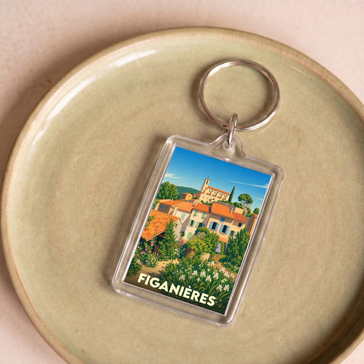 Porte-clés souvenir de la ville de Figanières avec une illustration colorée de style vintage.