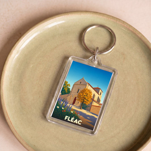 Porte-clés souvenir de la ville de Fléac avec une illustration stylisée de son église.
