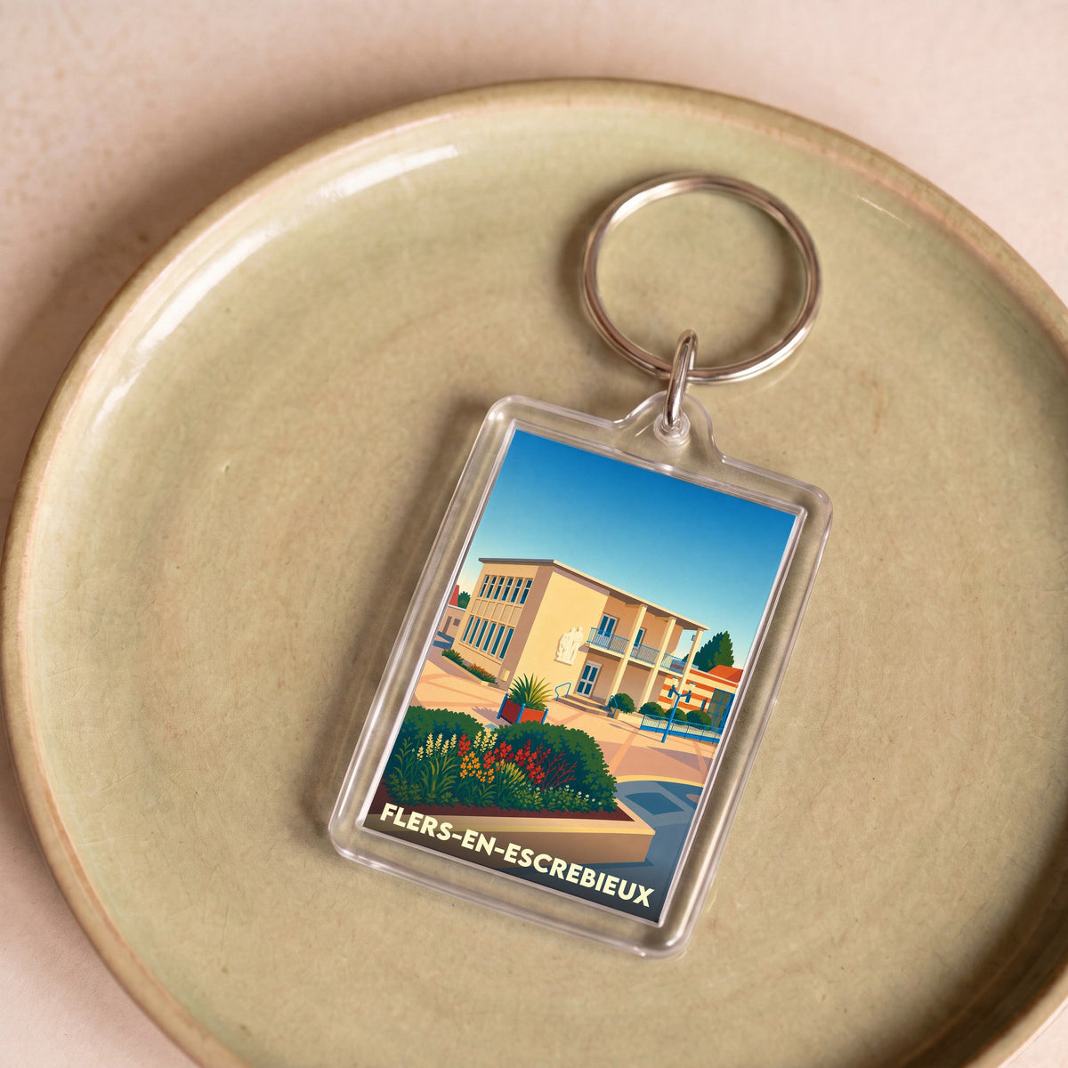 Porte-clés souvenir de la ville de Flers-en-Escrebieux avec une illustration stylisée.