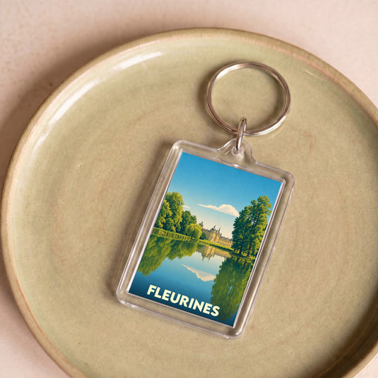 Porte-clés souvenir de la ville de Fleurines avec une illustration stylisée de son paysage.