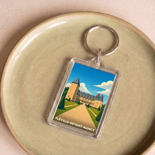 Porte-clés souvenir de Fléville-devant-Nancy avec une illustration stylisée de son château.