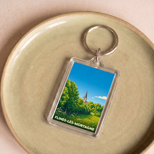 Porte-clés souvenir de la ville de Flines-lès-Mortagne avec une illustration paysagère stylisée.