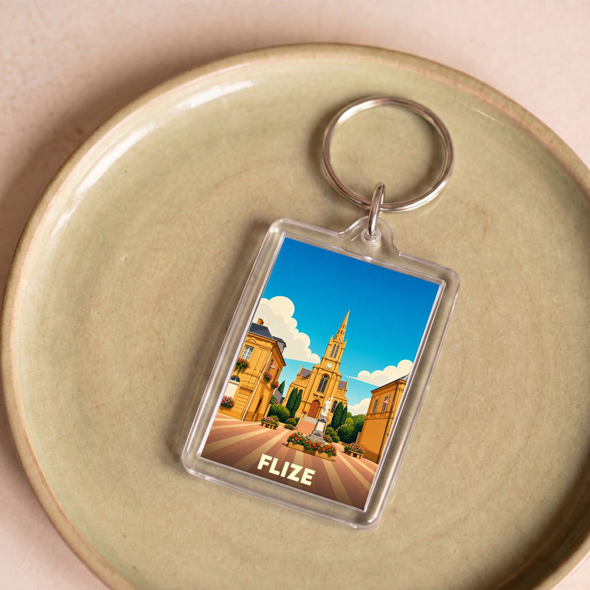 Porte-clés souvenir de la ville de Flize avec une illustration stylisée.