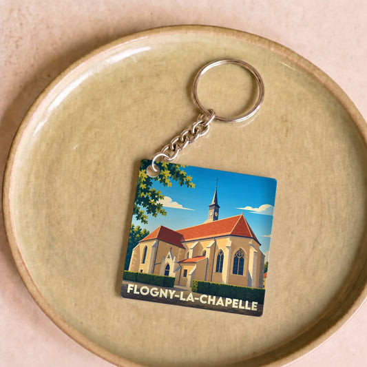 Porte-clés souvenir de la ville de Flogny-la-Chapelle avec une illustration stylisée de son église.