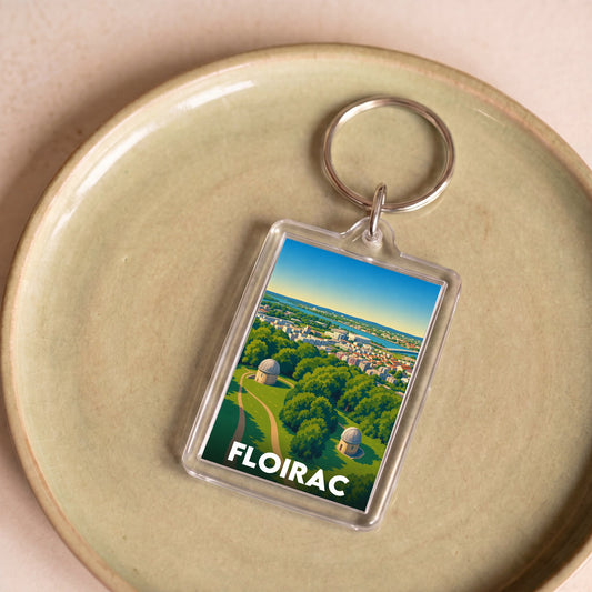Porte-clés souvenir de la ville de Floirac avec une illustration paysagère stylisée.