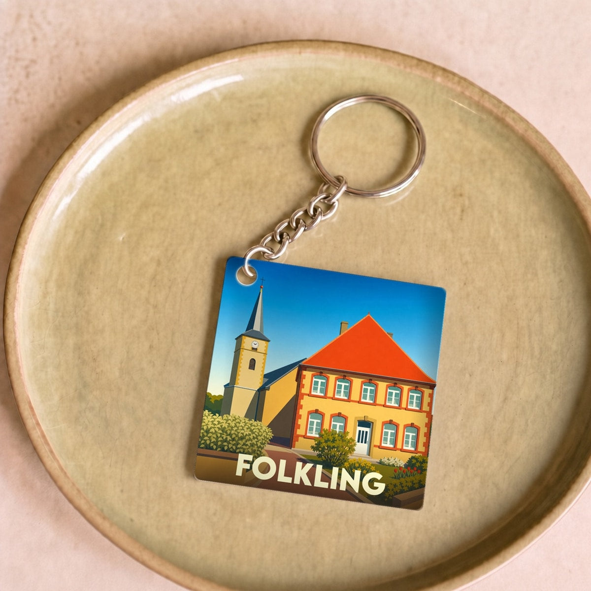 Porte-clés souvenir de la ville de Folkling avec une illustration stylisée.