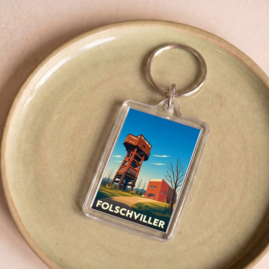 Porte-clés souvenir de la ville de Folschviller avec une illustration stylisée de son puits de mine.