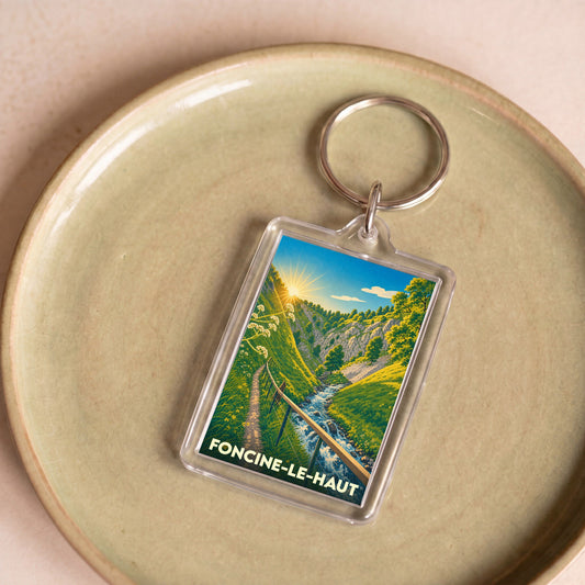 Porte-clés souvenir de la ville de Foncine-le-Haut avec une illustration stylisée de ses paysages montagneux.