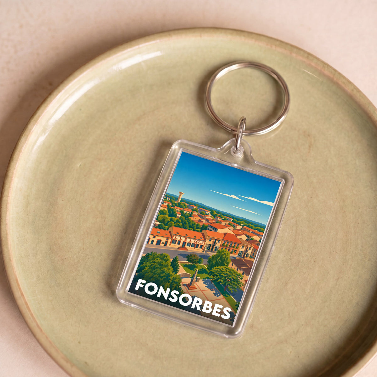 Porte-clés souvenir de la ville de Fonsorbes avec une illustration stylisée de ses paysages.