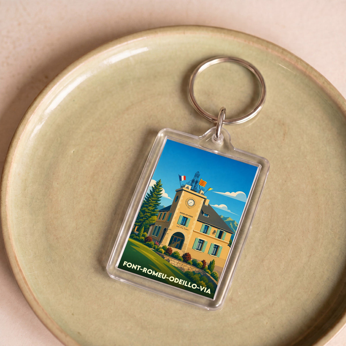 Porte-clés souvenir de la ville de Font-Romeu-Odeillo-Via avec une illustration stylisée.