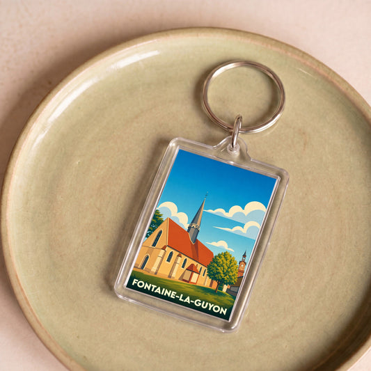 Porte-clés souvenir de la ville de Fontaine-la-Guyon avec une illustration stylisée de son église.