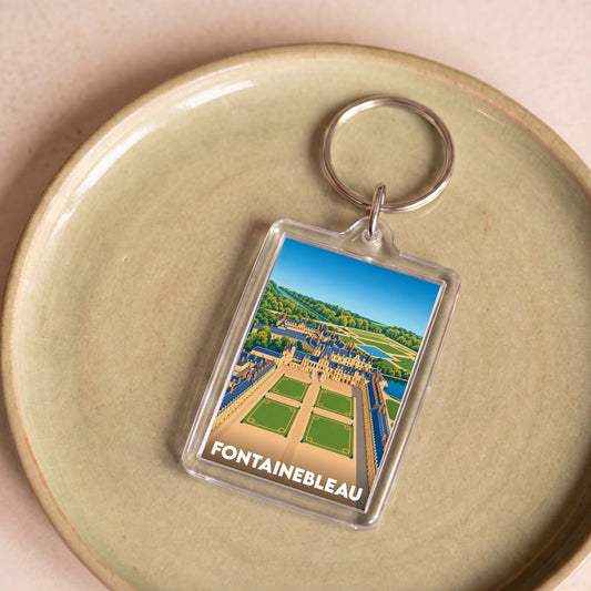Porte-clés souvenir de la ville de Fontainebleau avec une illustration stylisée de son château.