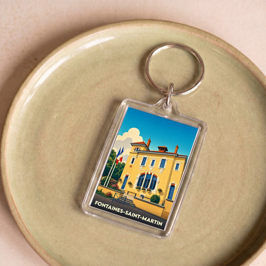 Porte-clés souvenir de la ville de Fontaines-Saint-Martin avec une illustration stylisée de sa mairie.