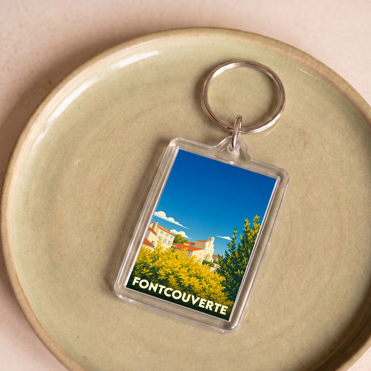 Porte-clés souvenir de la ville de Fontcouverte avec une illustration stylisée.