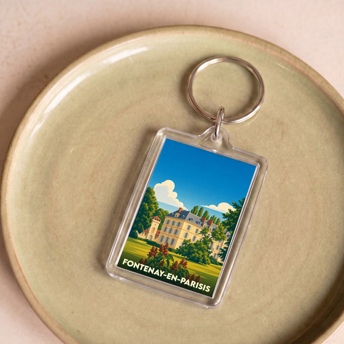 Porte-clés souvenir de la ville de Fontenay-en-Parisis avec une illustration stylisée d'un château.