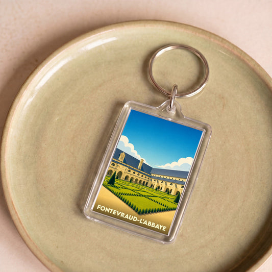 Porte-clés souvenir de la ville de Fontevraud-l'Abbaye avec une illustration stylisée de son abbaye et de ses jardins.