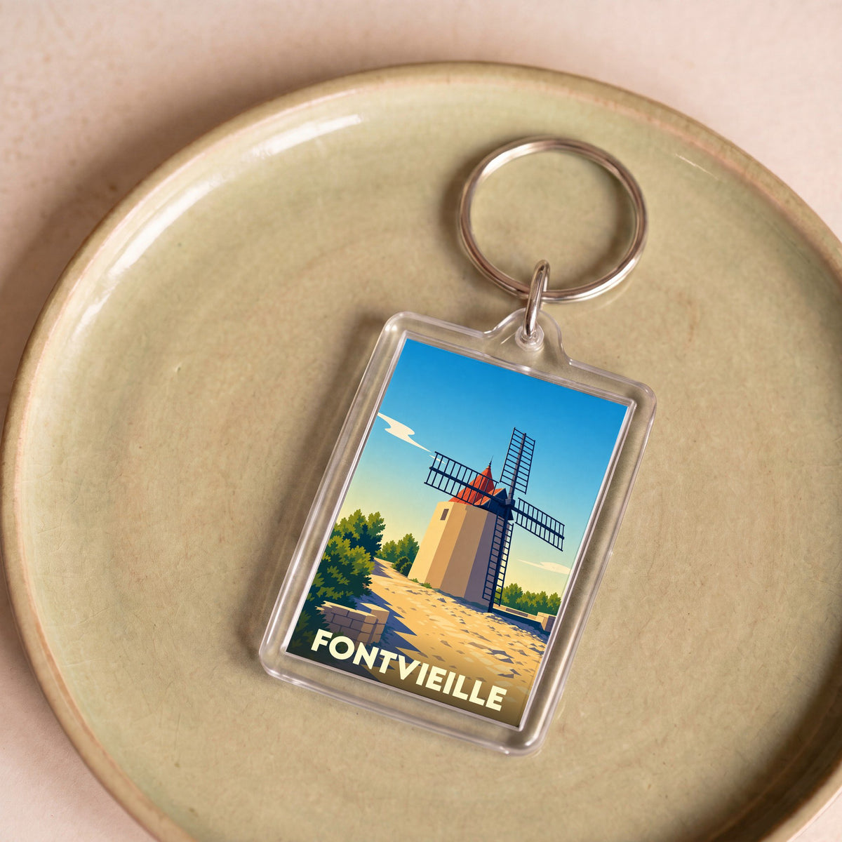 Porte-clés souvenir de la ville de Fontvieille avec une illustration stylisée d'un moulin.
