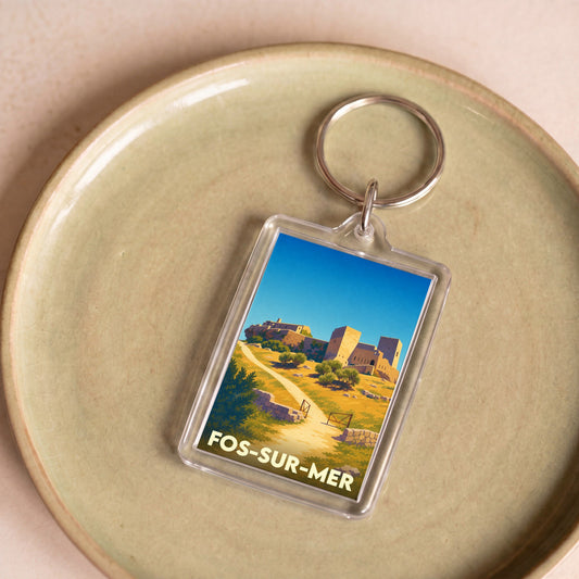 Porte-clés souvenir de la ville de Fos-sur-Mer avec une illustration stylisée de son patrimoine historique.