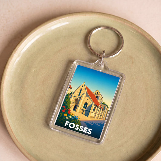 Porte-clés souvenir de la ville de Fosses avec une illustration stylisée de son église.