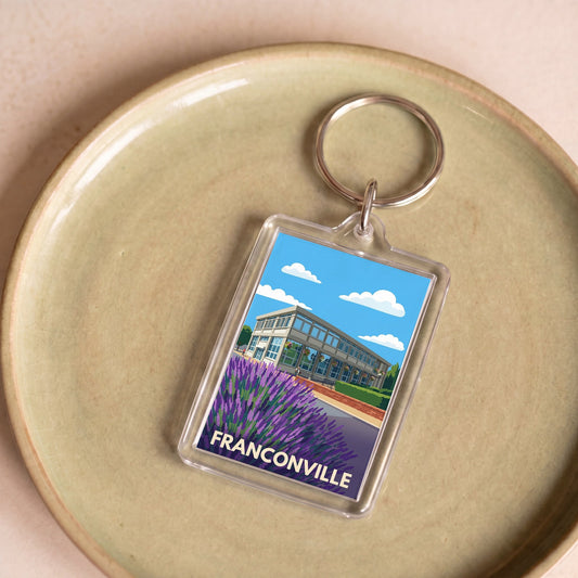 Porte-clés souvenir de la ville de Franconville avec une illustration stylisée.