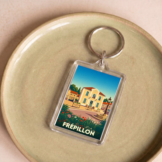 Porte-clés souvenir de la ville de Frépillon avec une illustration stylisée.