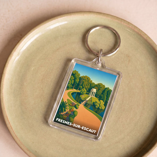 Porte-clés souvenir de la ville de Fresnes-sur-Escaut avec une illustration stylisée d'un parc.