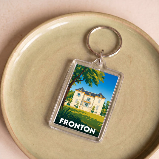 Porte-clés souvenir de la ville de Fronton avec une illustration stylisée d'une demeure bourgeoise.