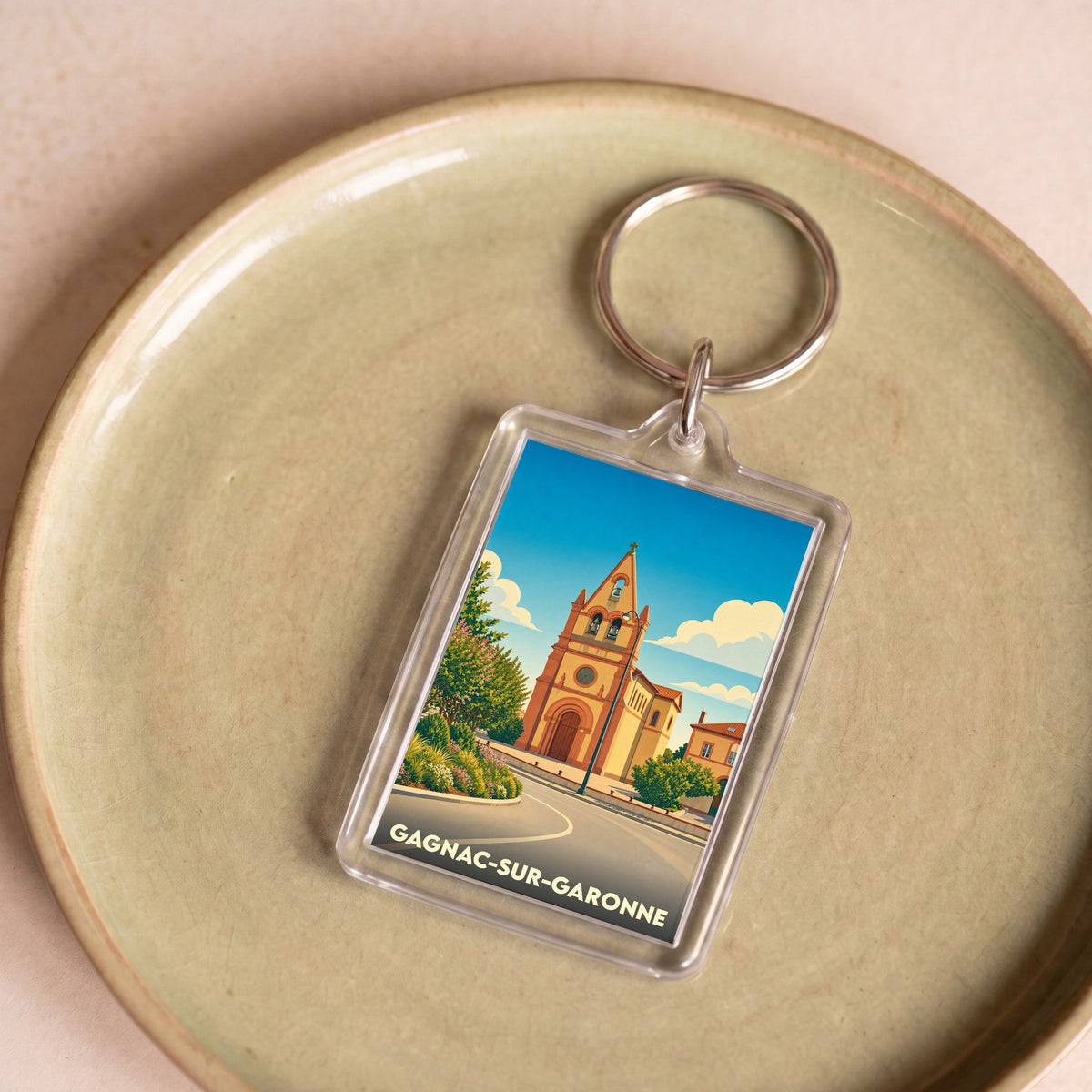 Porte-clés souvenir de la ville de Gagnac-sur-Garonne avec une illustration stylisée de son église.
