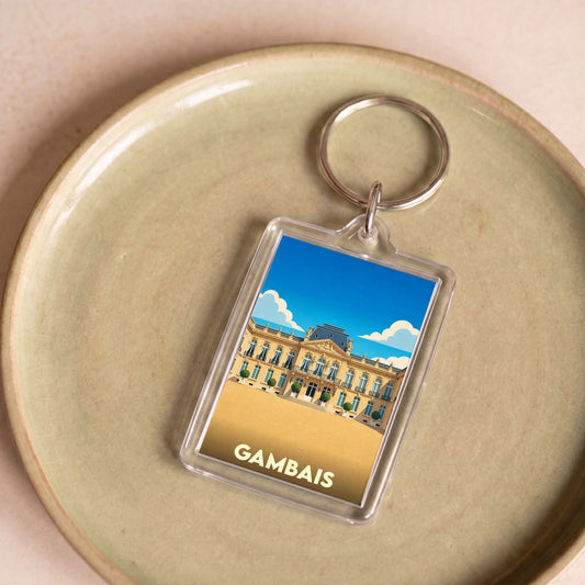 Porte-clés souvenir de la ville de Gambais avec une illustration stylisée d'un château.