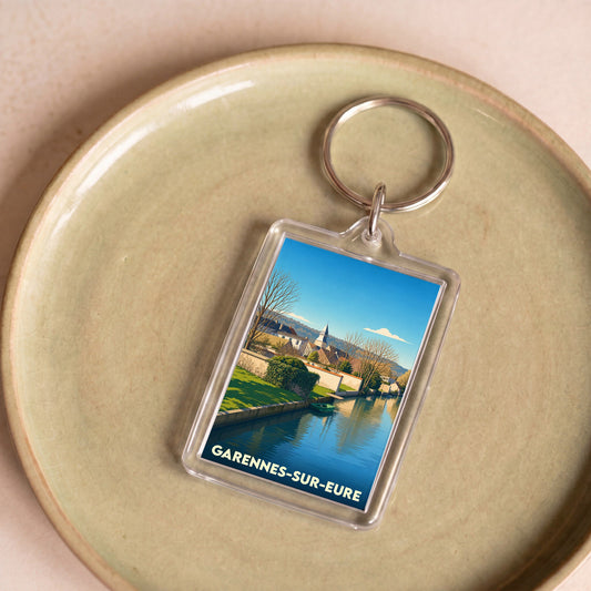 Porte-clés souvenir de la ville de Garennes-sur-Eure avec une illustration stylisée.