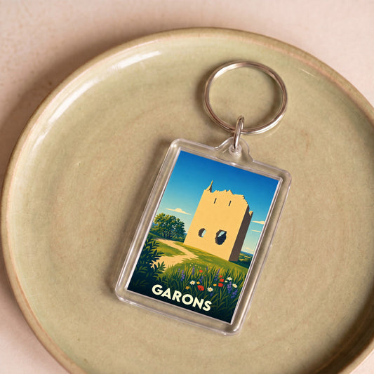Porte-clés souvenir de la ville de Garons avec une illustration stylisée d'une tour historique.