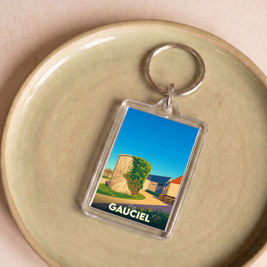 Porte-clés souvenir de la ville de Gauciel avec une illustration stylisée d'une tour en pierre.