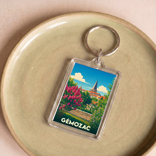 Porte-clés souvenir de la ville de Gémozac avec une illustration stylisée et colorée.