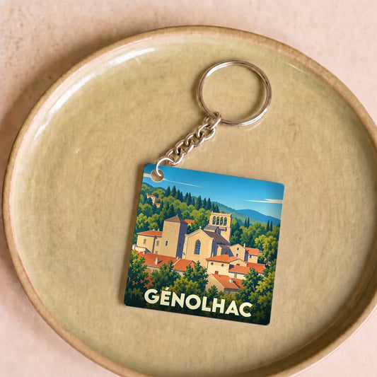 Porte-clés souvenir de la ville de Génolhac avec une illustration stylisée.