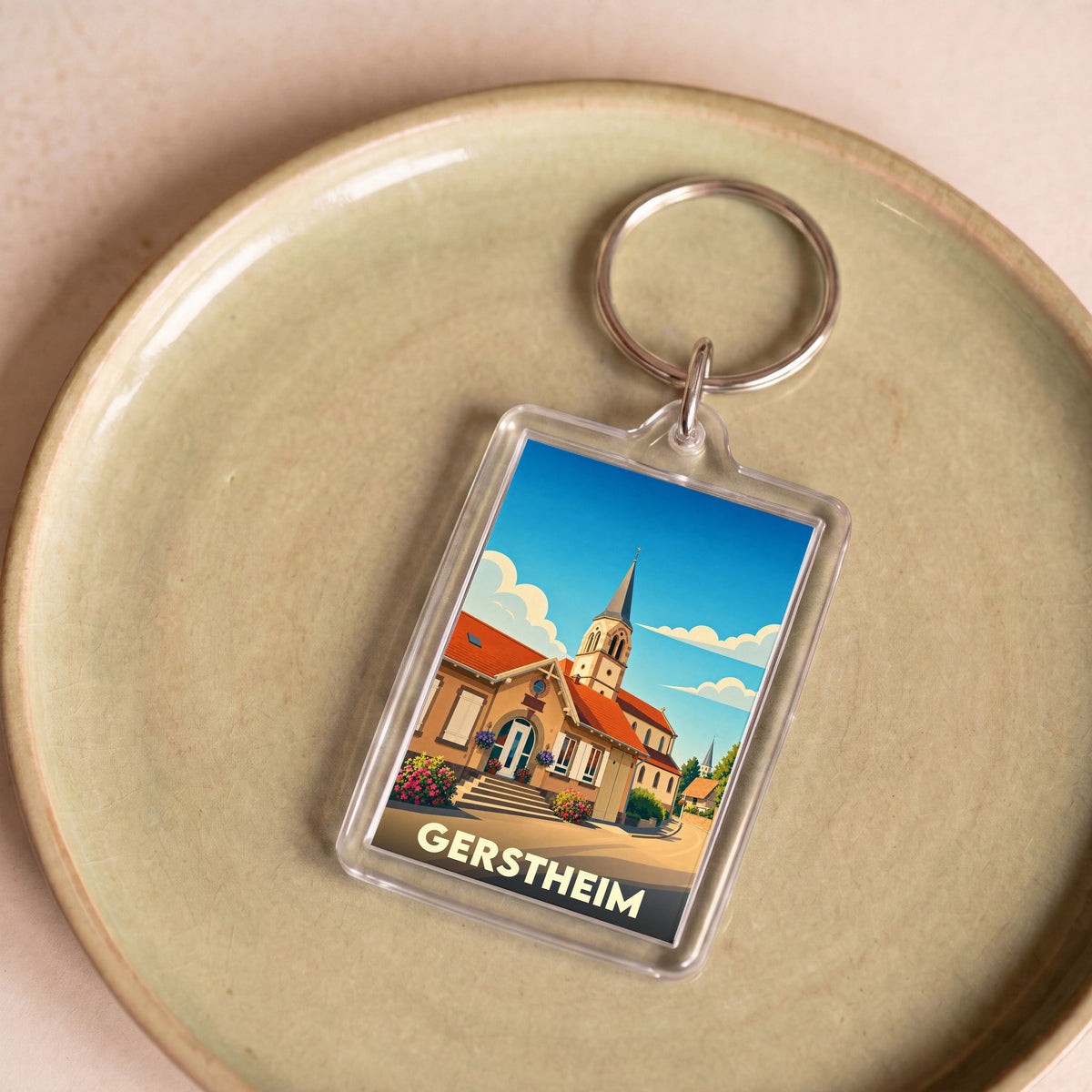 Porte-clés souvenir de la ville de Gerstheim avec une illustration stylisée.