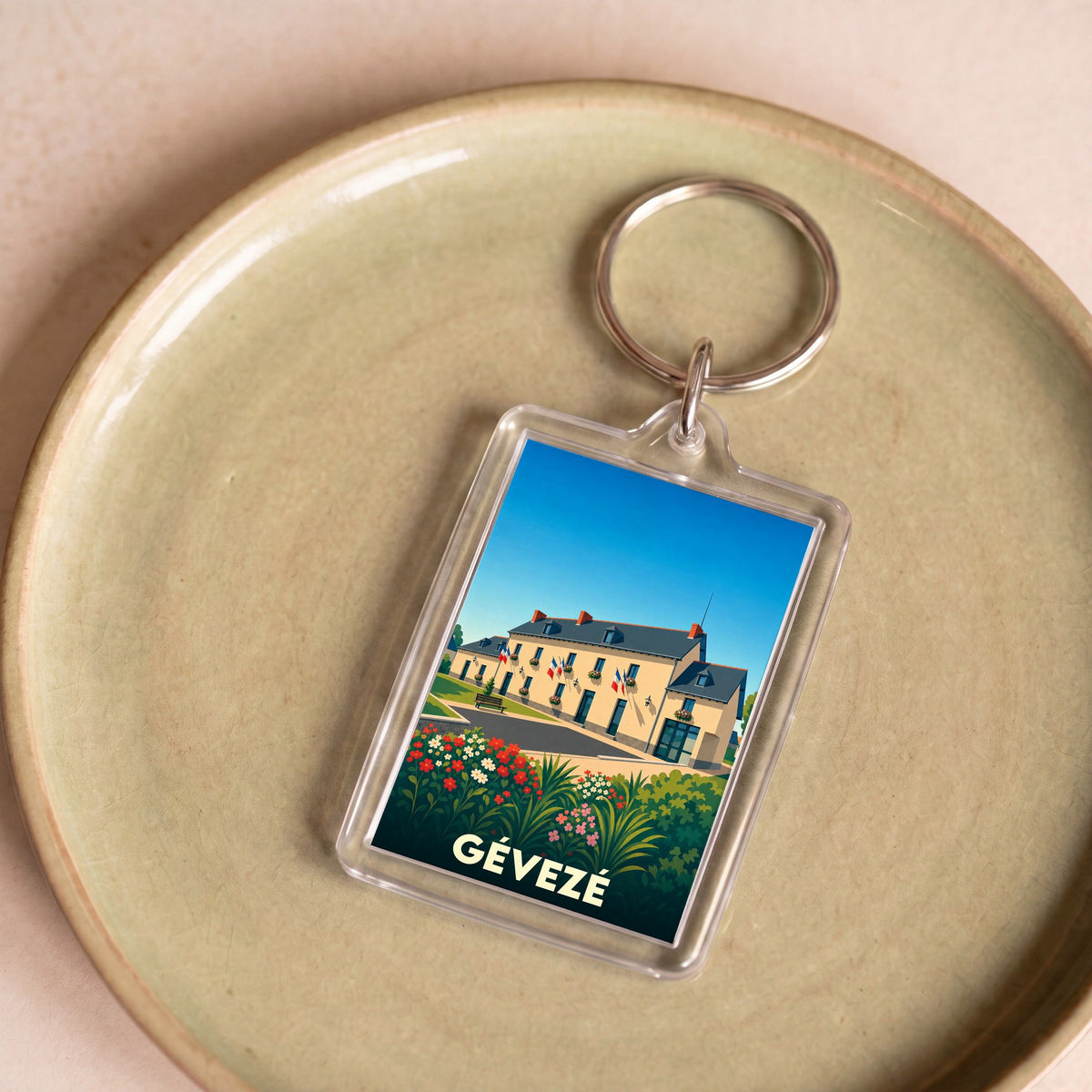 Porte-clés souvenir de la ville de Gévezé avec une illustration stylisée.