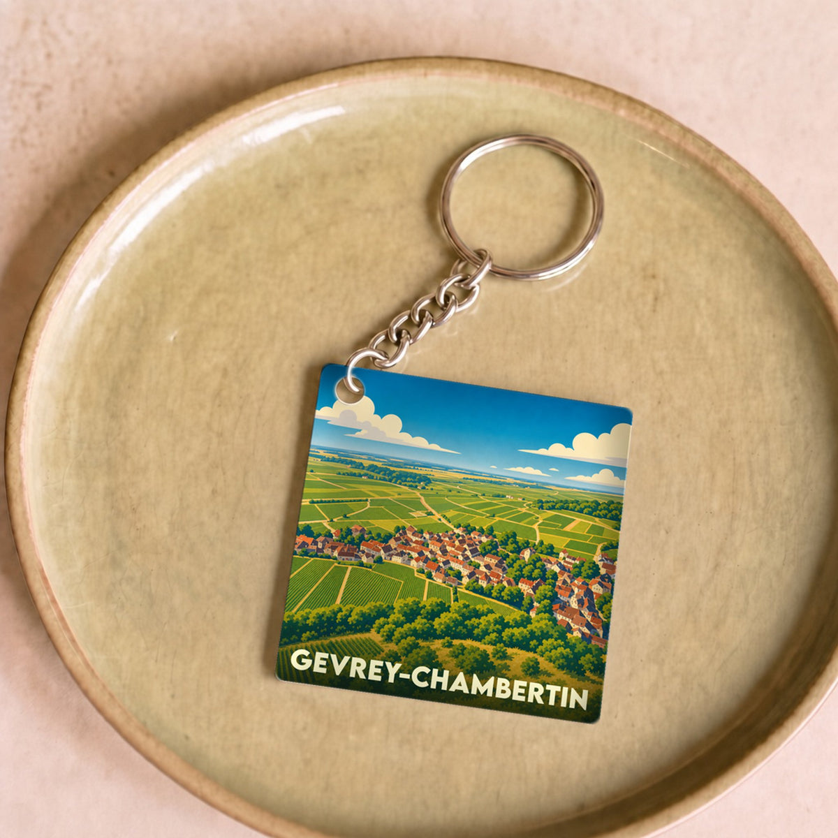 Porte-clés souvenir de la ville de Gevrey-Chambertin avec une illustration stylisée de son vignoble.