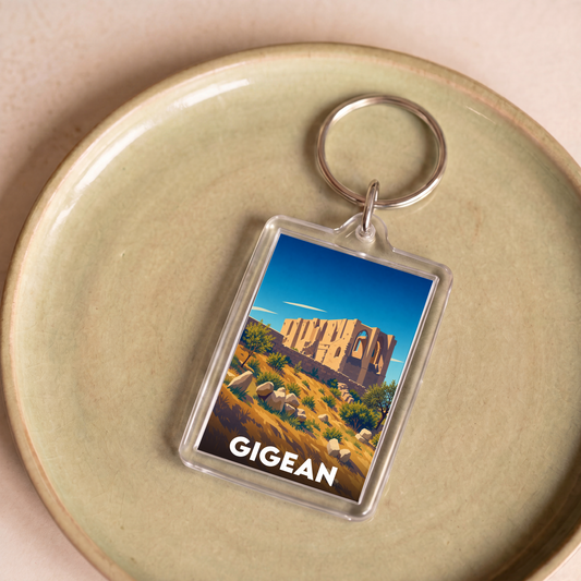 Porte-clés souvenir de la ville de Gigean avec une illustration stylisée de l'abbaye Saint-Félix-de-Montceau.