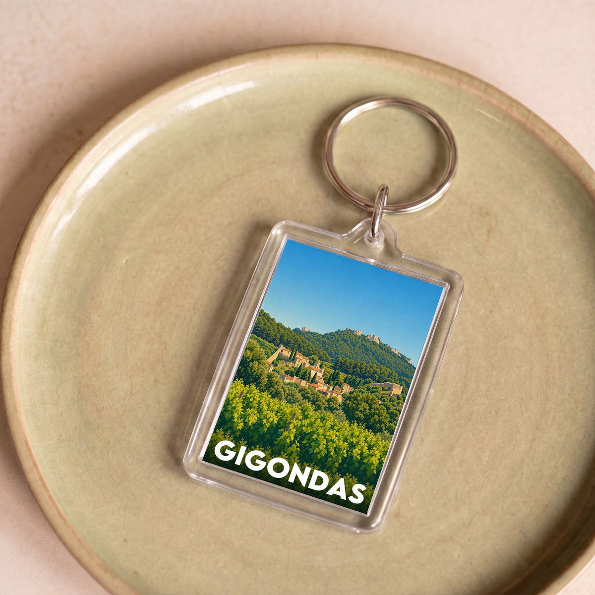 Porte-clés souvenir de la ville de Gigondas avec une illustration stylisée.